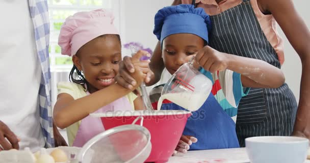 Happy family preparing food in kitchen — Stock Video