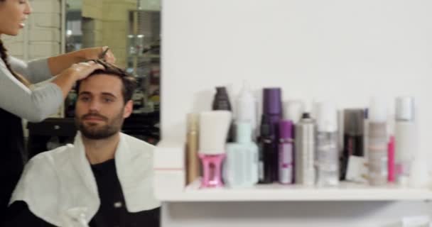 Hairdressers trimming their client hair — Stock Video