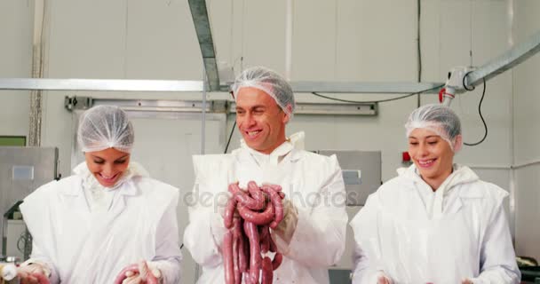 Team of butchers holding sausages — Stock Video