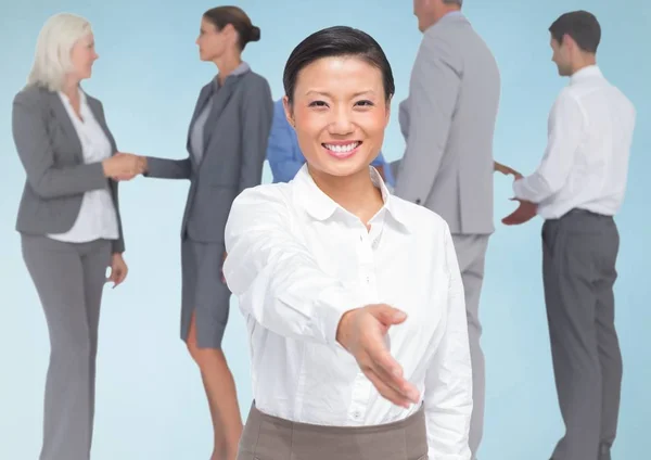 Handshake in front of business people — Stock Photo, Image