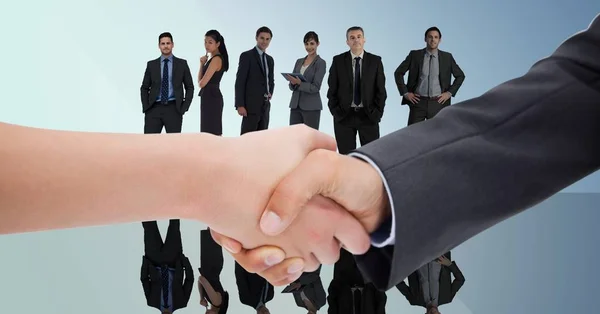 Handshake in front of business people — Stock Photo, Image