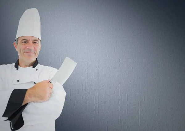 Chef com faca contra fundo cinza — Fotografia de Stock