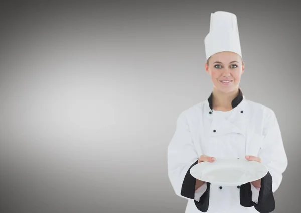 Chef with plate against grey background — Stock Photo, Image