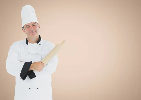 Chef with rolling pin against cream background — Stock Photo, Image