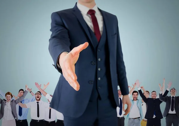 Composite image of Handshake in front of business people with blue background — Stock Photo, Image