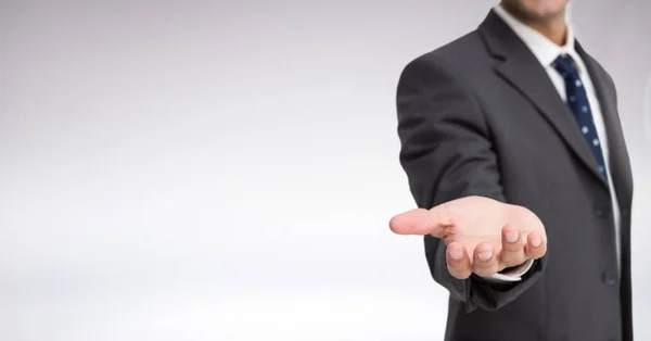 Businessman Torso who is stretching his hand against a neutral background — Stock Photo, Image