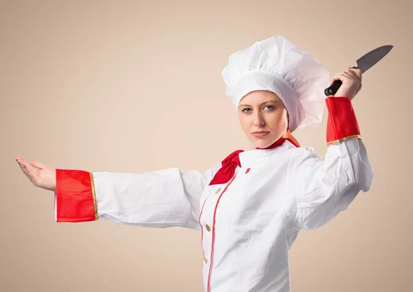 Chef con coltello contro sfondo crema — Foto Stock