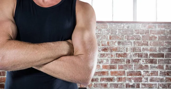 Man torso with black shirt against stone and windows wall — Stock Photo, Image