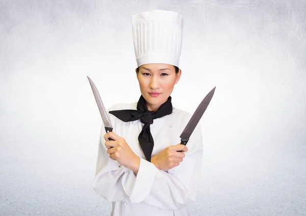 Composite image of Chef with knives against white background — Stock Photo, Image