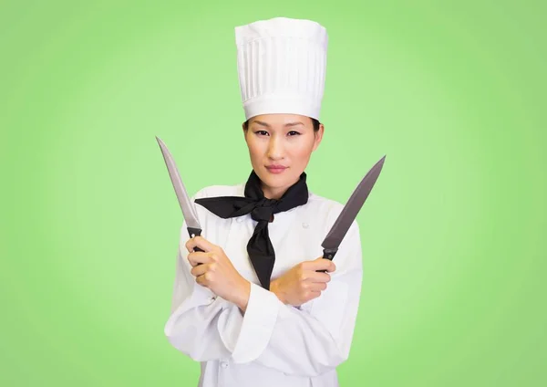 Chef with knives against green background — Stock Photo, Image