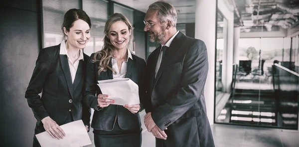 Happy businesspeople discussing over report — Stock Photo, Image