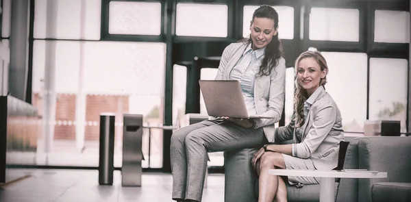 Businesswomen sitting with laptop — Stock Photo, Image