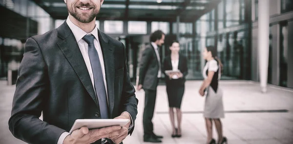 Happy businessman holding digital tablet — Stock Photo, Image