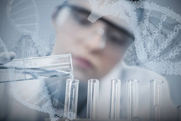 Female scientist pouring chemical — Stock Photo, Image