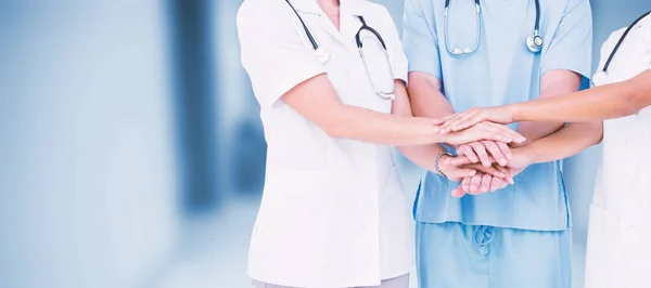 Doctors putting hands together — Stock Photo, Image