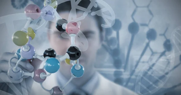 Scientist holding multi colored molecule structure — Stock Photo, Image