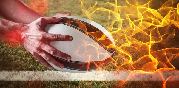 Hand holding rugby ball — Stock Photo, Image