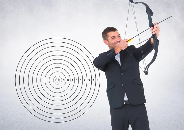 Businessman aiming at the target board against grey background — Stock Photo, Image
