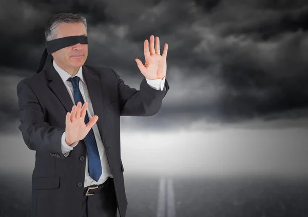 Businessman in blindfold against storm cloud — Stock Photo, Image