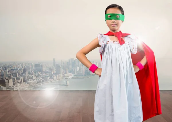 Portrait of super kid in red cape and green mask standing with hand on hip — Stock Photo, Image
