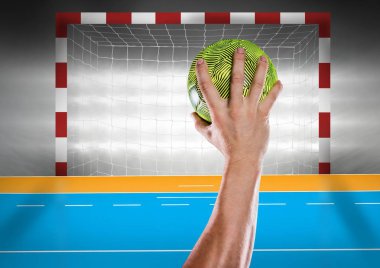 Athlete throwing handball against stadium in background clipart