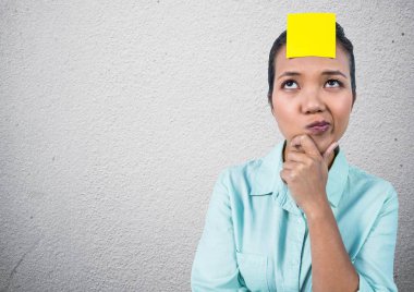 Thoughtful woman with sticky note on her forehead clipart