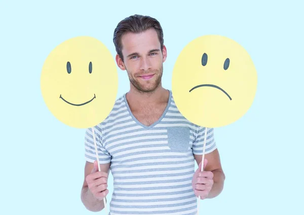 Man holding a smiley face and sad face — Stock Photo, Image