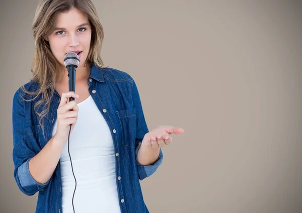 Portrait of beautiful woman singing a song on microphone — Stock Photo, Image