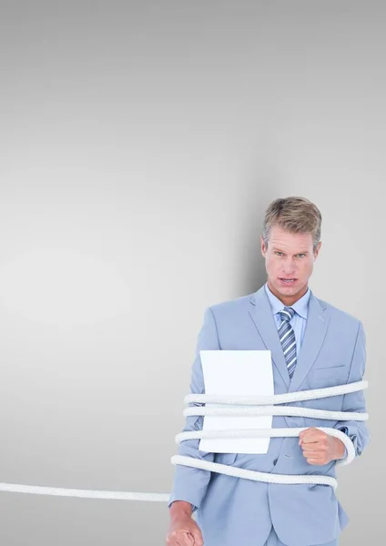 Businessman tied up in rope — Stock Photo, Image