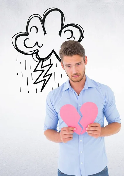 Homem deprimido segurando coração partido contra fundo branco — Fotografia de Stock