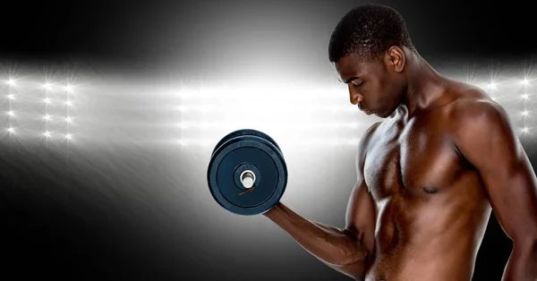 Muscular man lifting a dumbbell — Stock Photo, Image