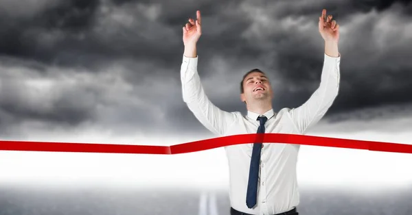 Excited businessman crossing the finish line — Stock Photo, Image