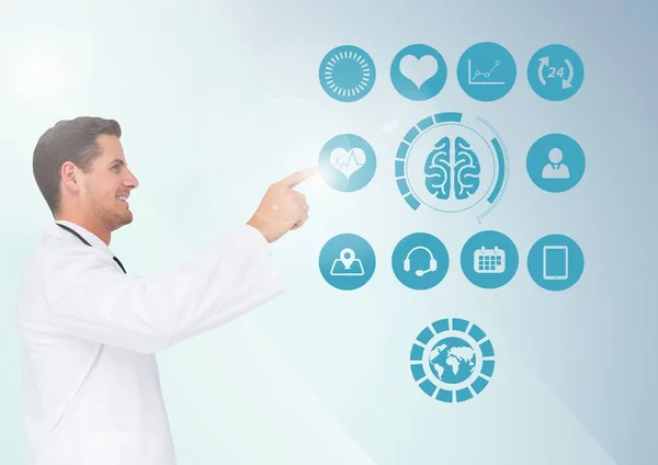 Doctor touching digitally generated medical icons — Stock Photo, Image