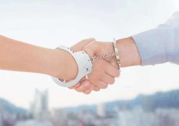 Handcuffed business people shaking hands — Stock Photo, Image