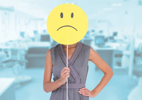 Businesswoman  holding sad smiley face — Stock Photo, Image