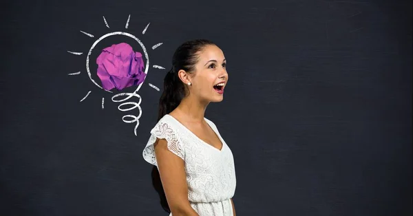 Cheerful woman standing next to light bulb — Stock Photo, Image