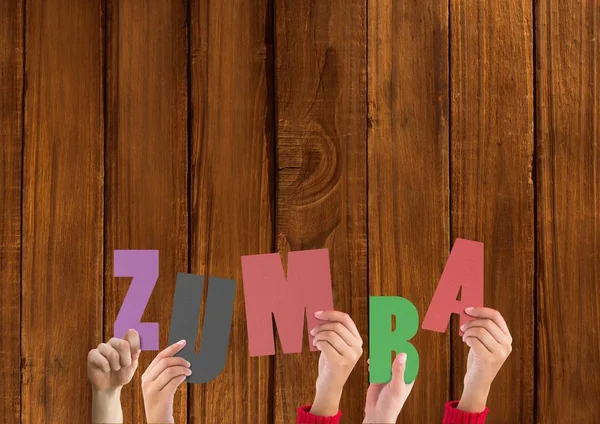 Χέρια που κρατούν την λέξη Zumba — Φωτογραφία Αρχείου