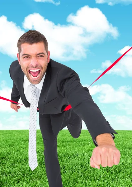 Businessman crossing finish line against sky — Stock Photo, Image