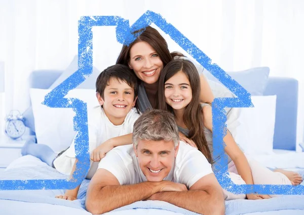 Family on bed together with house outline — Stock Photo, Image