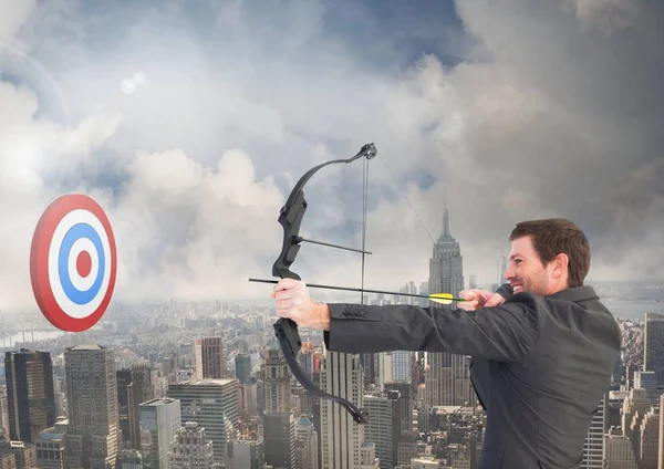 Businessman aiming at the target board — Stock Photo, Image