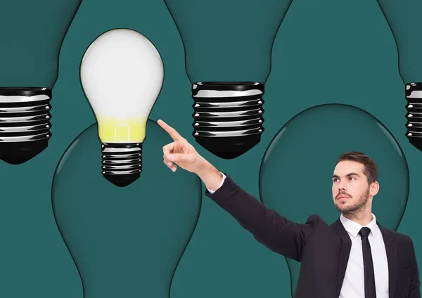 Businessman pointing at light bulb — Stock Photo, Image