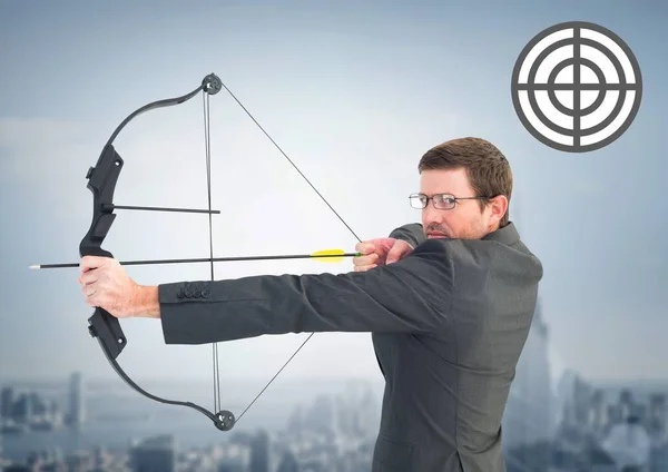 Portrait of businessman aiming with bow and arrow — Stock Photo, Image