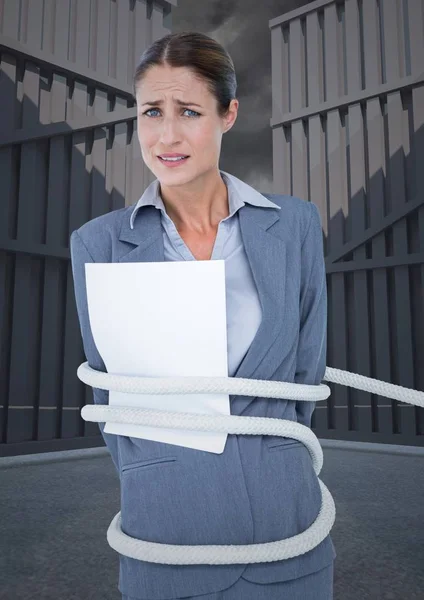 Tense businesswoman tied up with rope and paper — Stock Photo, Image