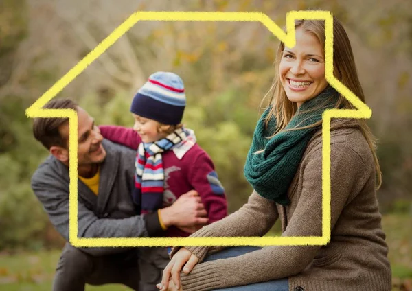 Home outline with happy family in park — Stock Photo, Image