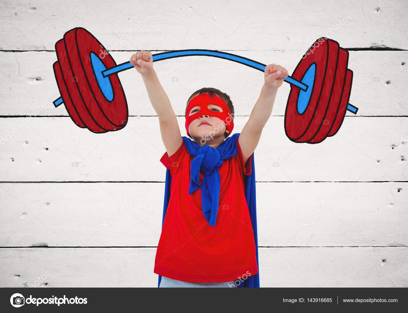 Boy In Superhero Costume Pretending To Lift Weights Against Wooden