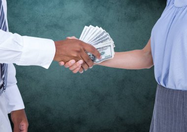 Businessman bribing partner while shaking hands clipart
