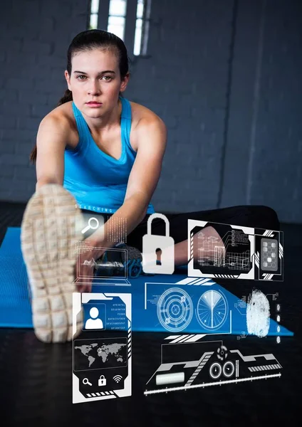 Portrait of woman exercising on mat and fitness interface — Stock Photo, Image