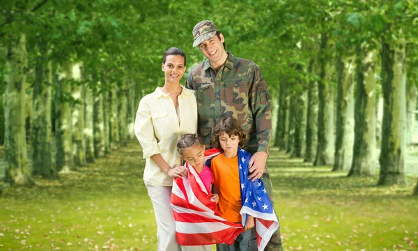 Military father and his family with american flag — Stock Photo, Image