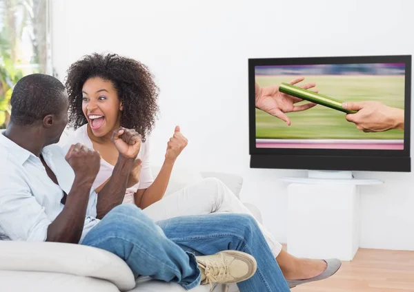 Excited couple cheering and watching sports — Stock Photo, Image