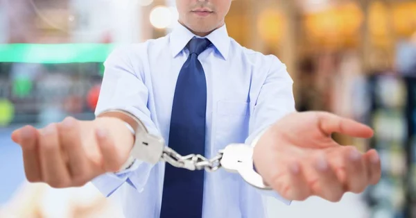 Businessman wearing handcuffs — Stock Photo, Image